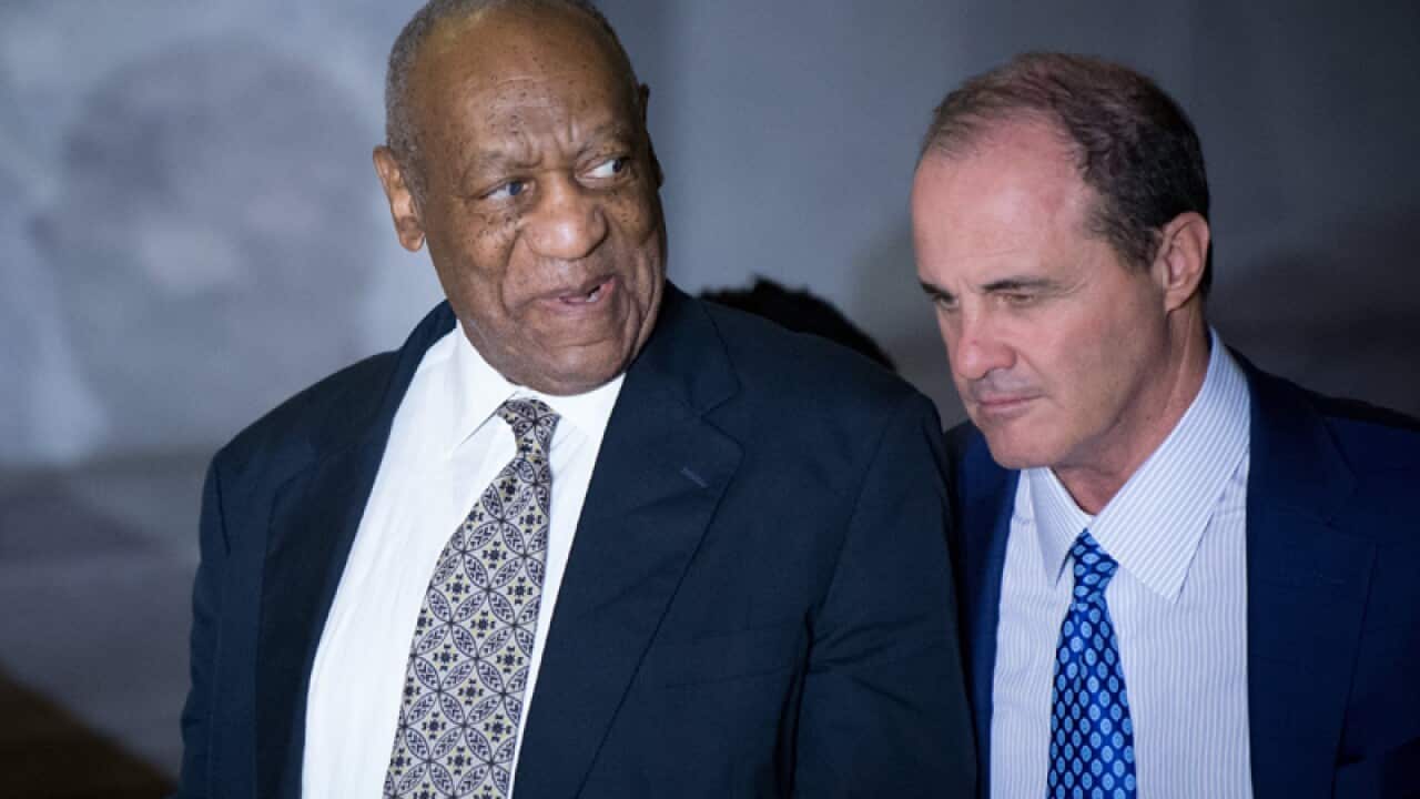 US entertainer Bill Cosby (L) departs the Montgomery County Courthouse