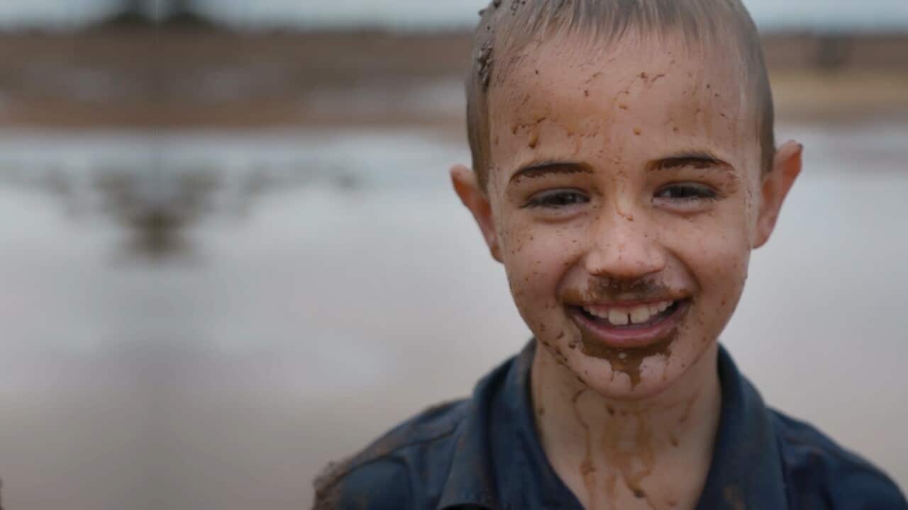A child smiles as rain falls in Tullamore