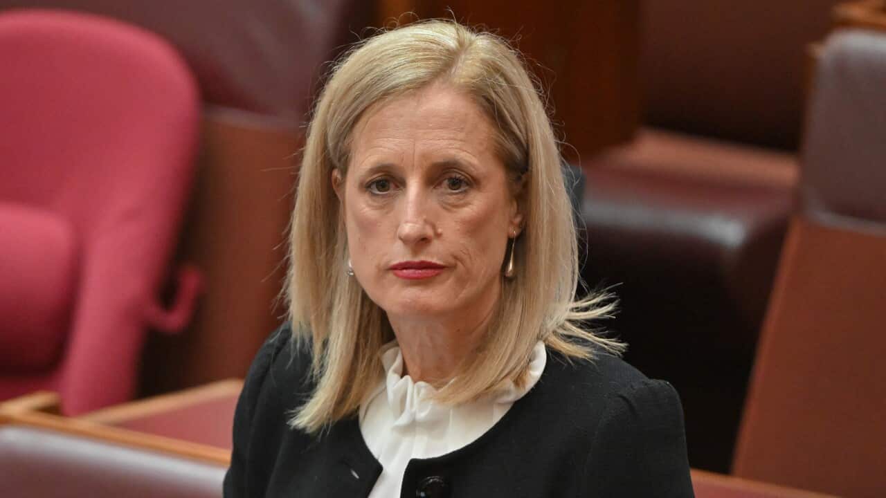 Woman in black jacket.