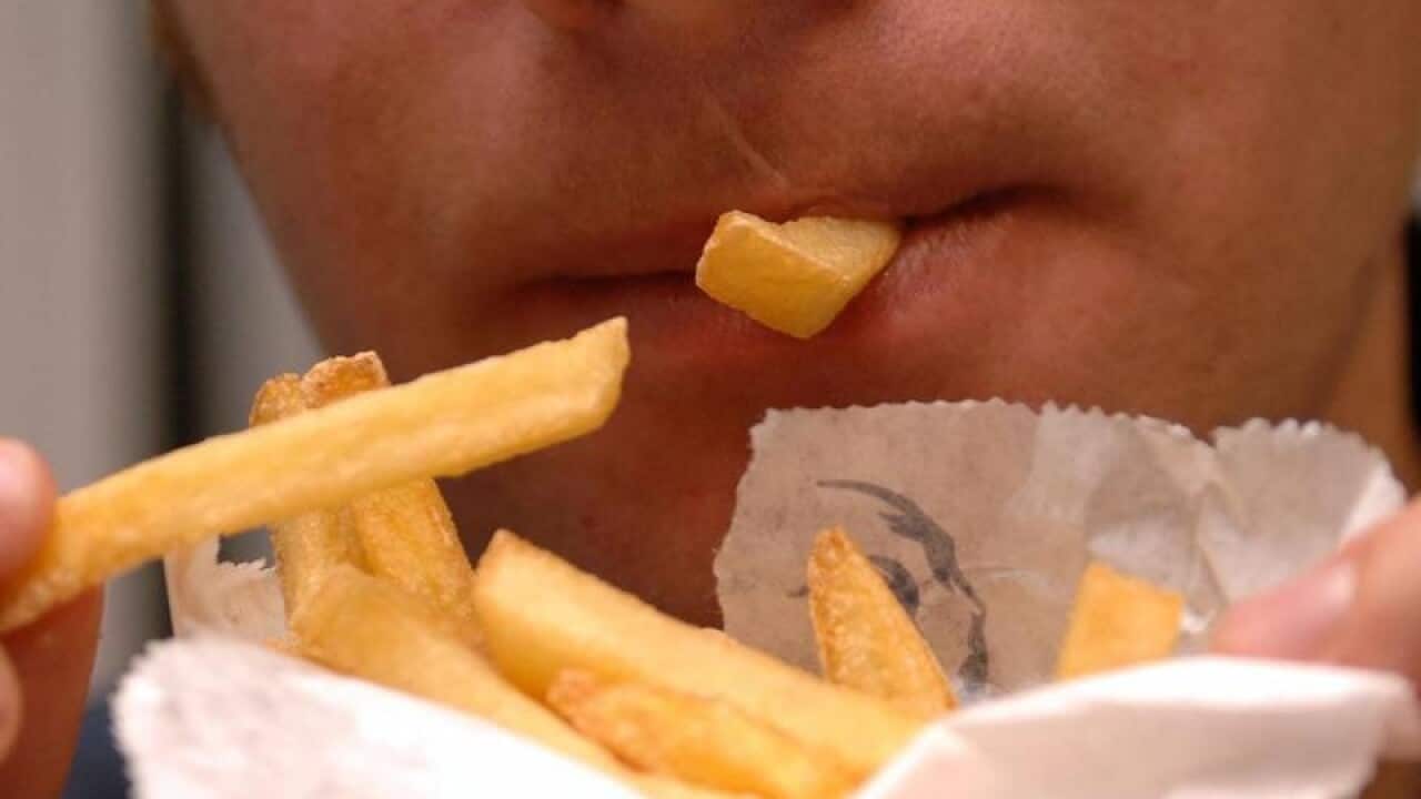 A man eating junk food