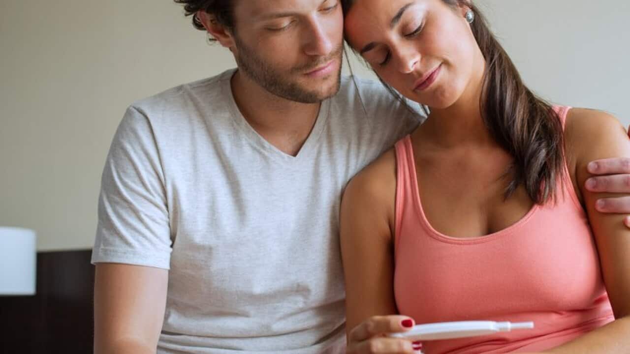 Couple looking at pregnancy test