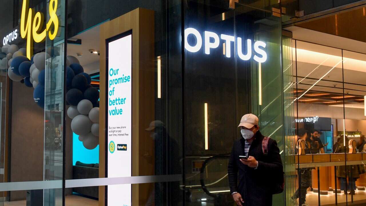 A man by an Optus store