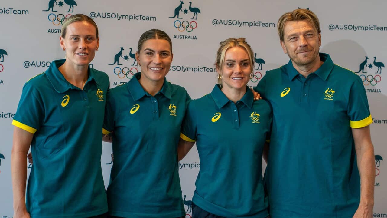 Three women stand to the left of a man wearing Australian Olympic shirts