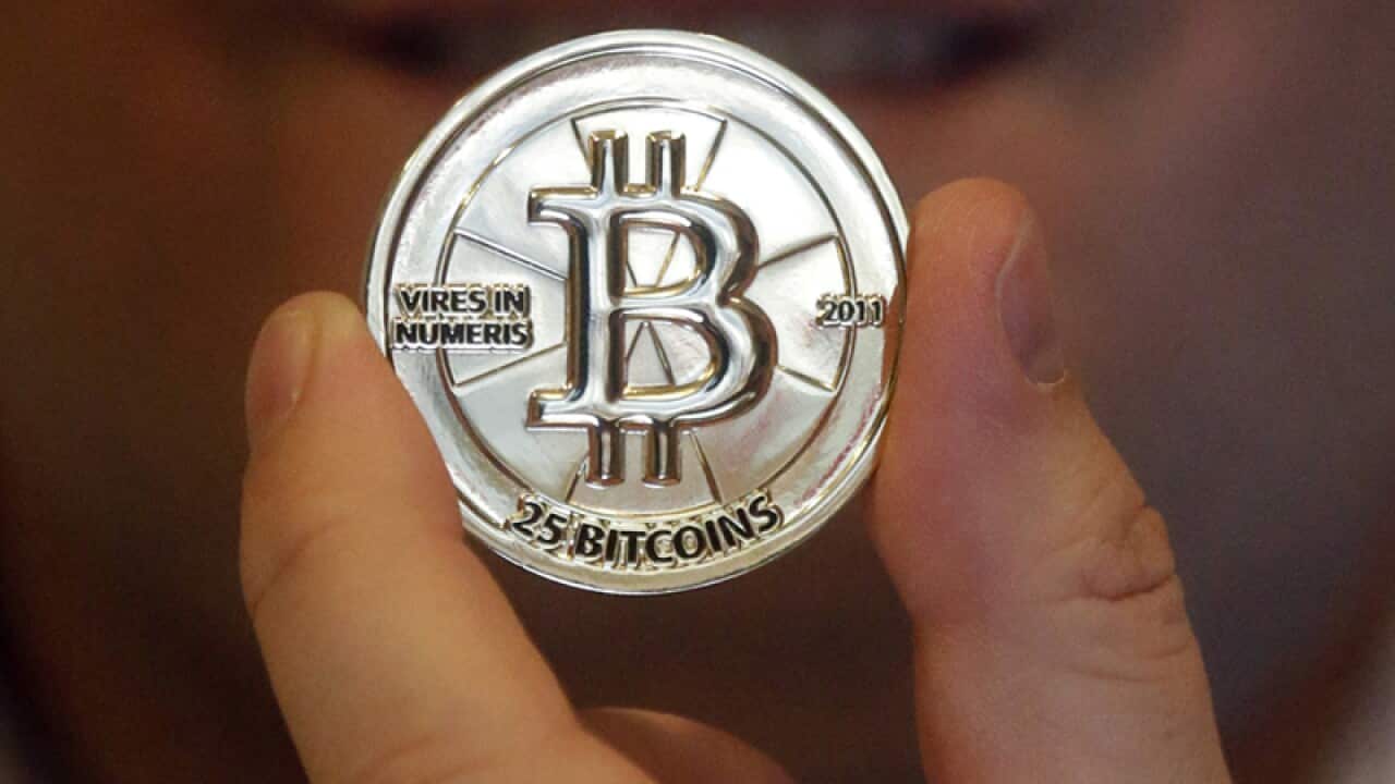 A 25 Bitcoin token at his shop in Sandy, Utah