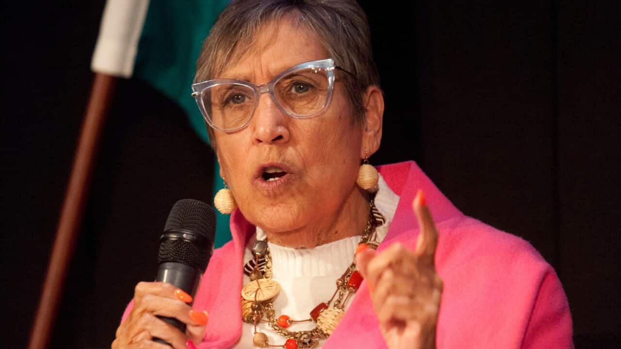 Stolen Generations survivor Jennifer Caruso holds a microphone