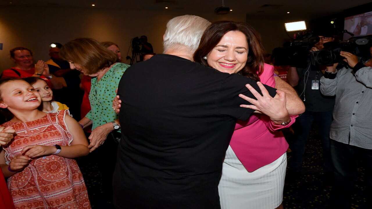 Queensland Premier Annastacia Palaszczuk (right) hugs her father Henry Palaszczuk after winning the Queensland State election.