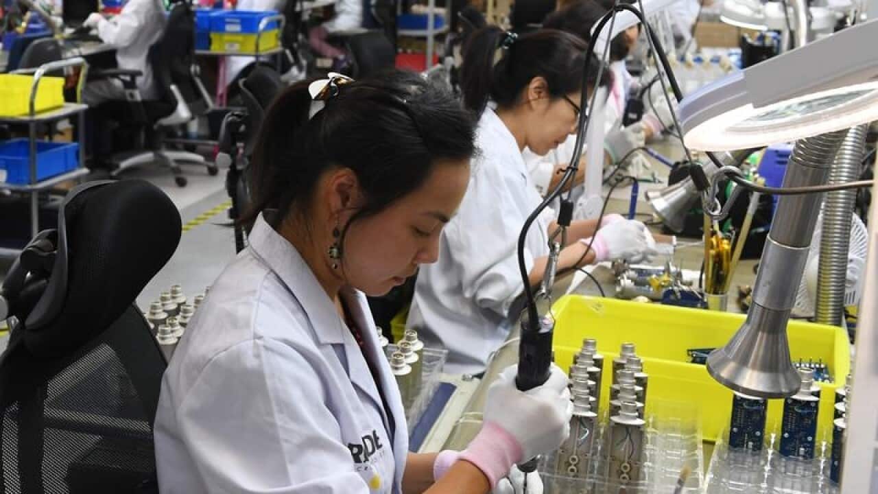A photo of workers at the Rode microphone factory.