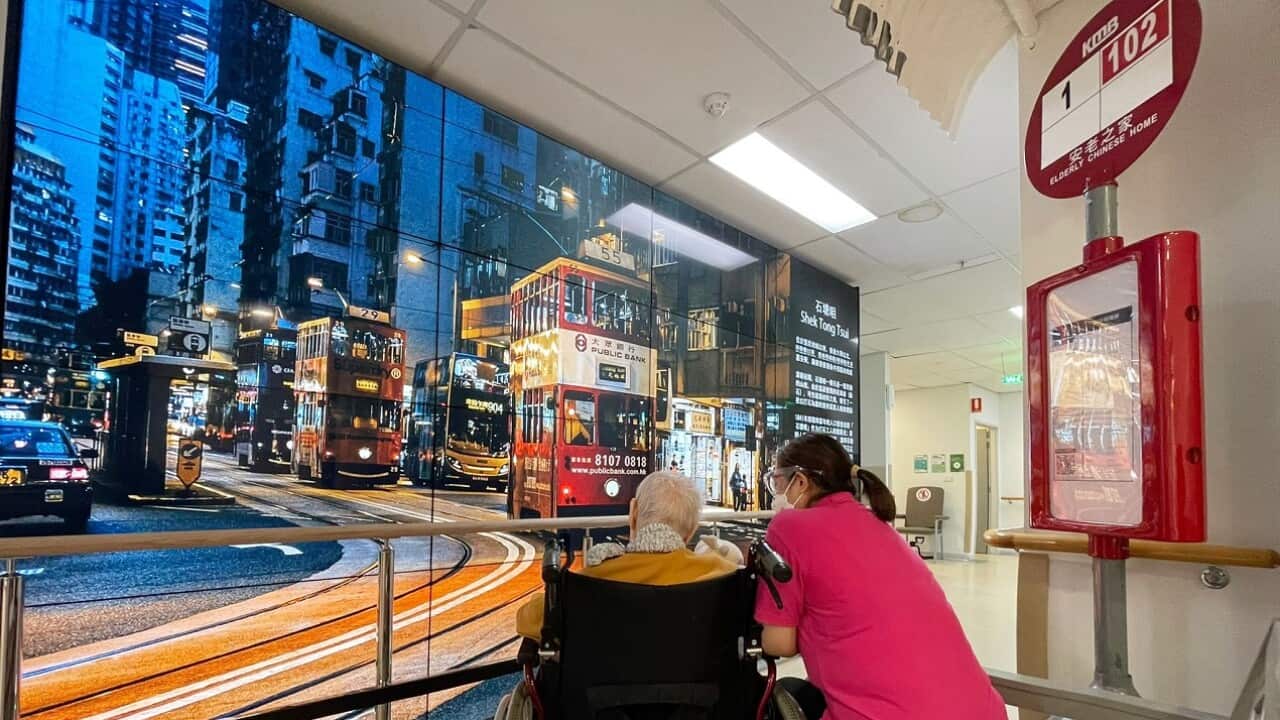 Residents at Elderly Chinese Home enjoy sitting at the bus stop.