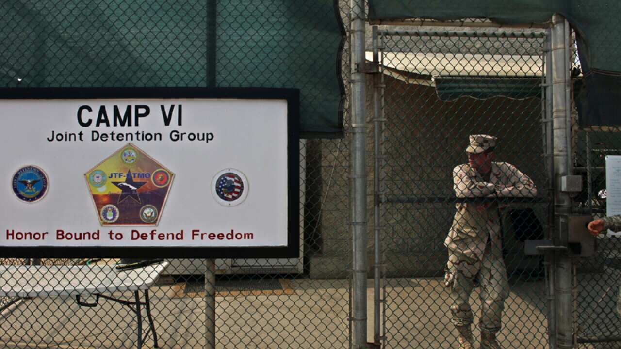 A soldier stands guard at the front gate entrance to Guantanamo
