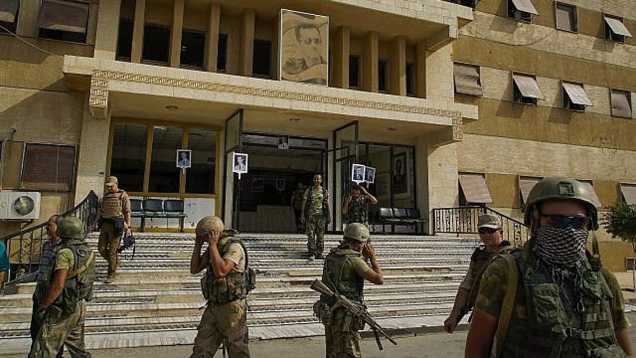 Russian military police soldiers walk out side a hospital in Deir el-Zour, Syria on 15th of September, 2017.