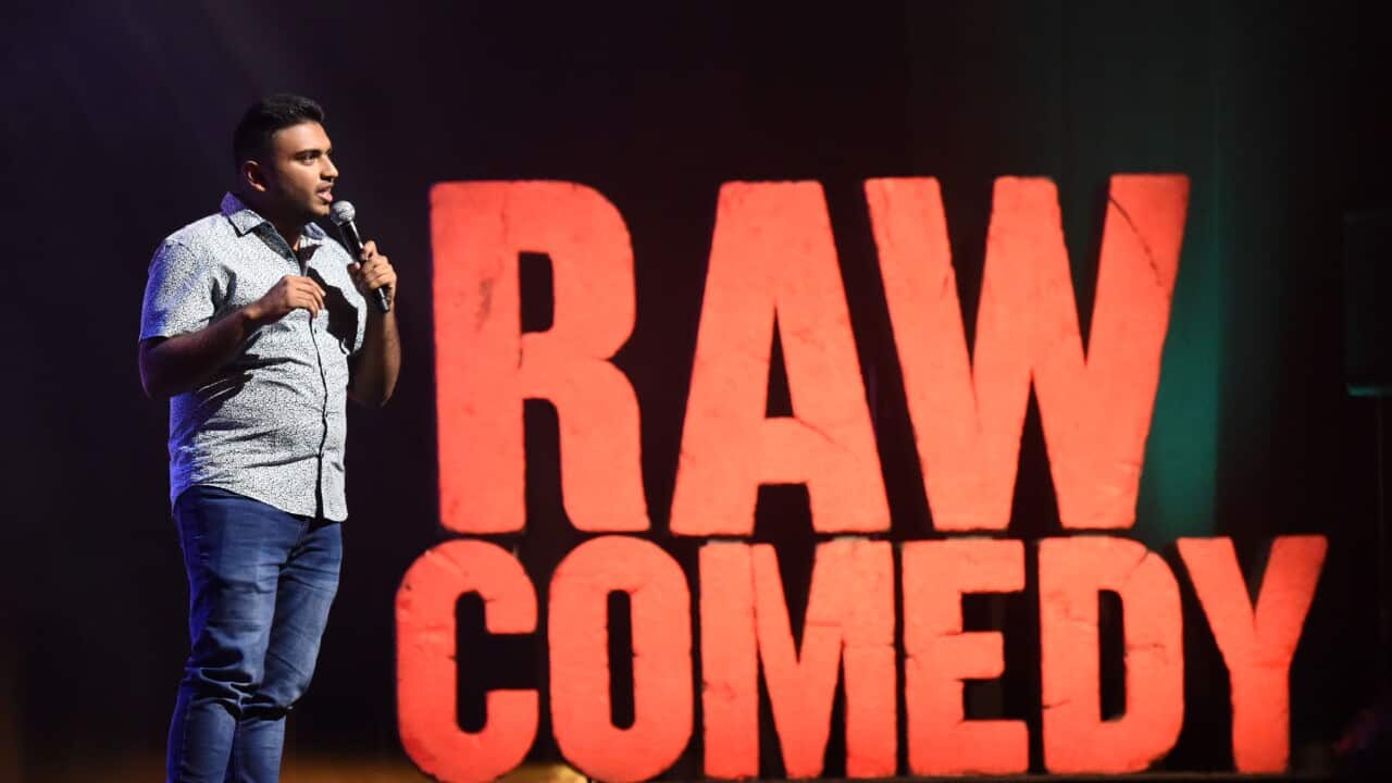 Comedian Suraj Kolarkar on stage performing at RAW Comedy Festival 2019.jpg