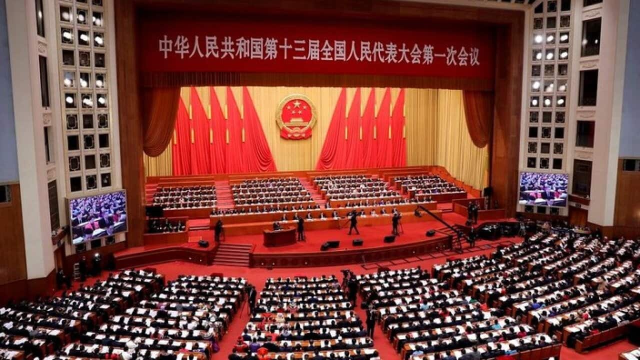 Deputies attend the opening meeting for the First Session of the 13th National People's Congress (NPC) at the Great Hall of the People in Beijing, China.