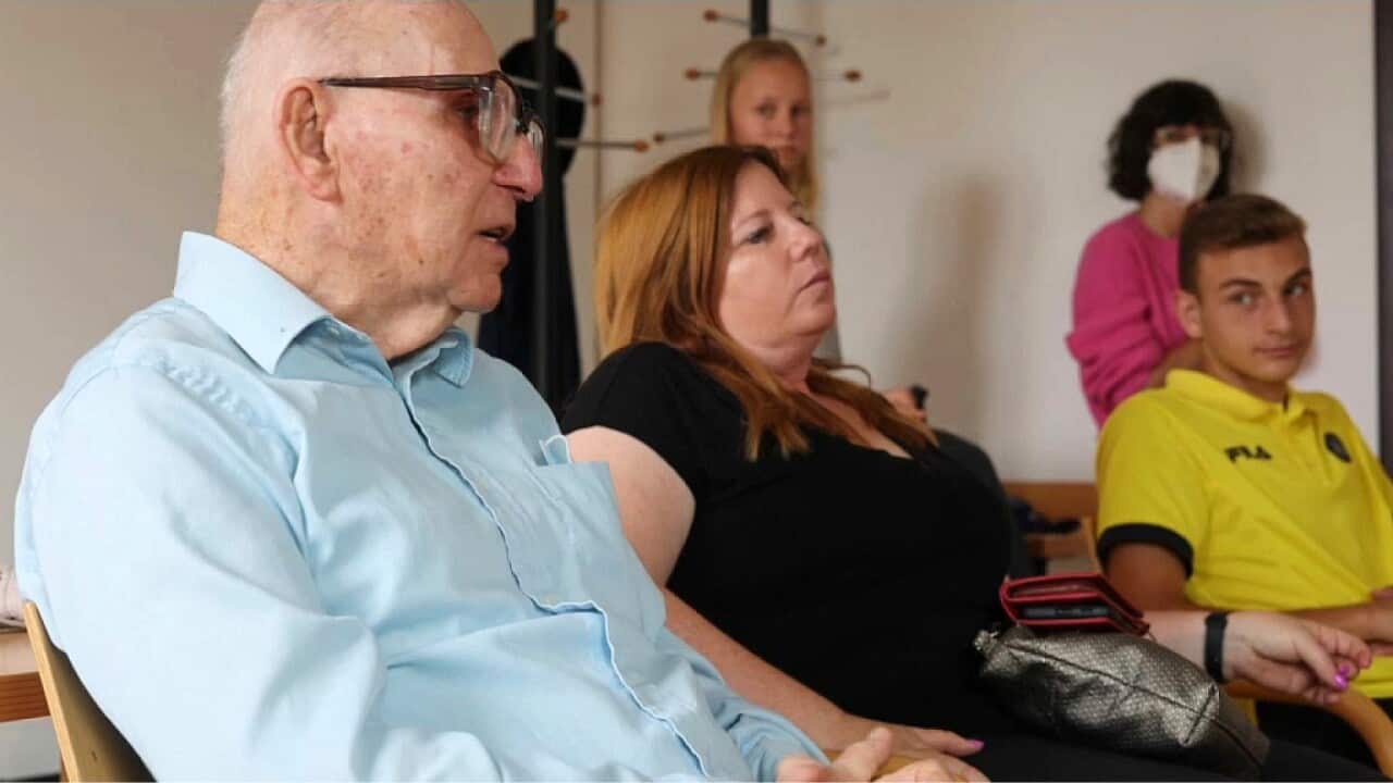 Holocaust survivor Shaul Paul Ladany (L) speaks to young footballers in Nuremberg (AP).jpg