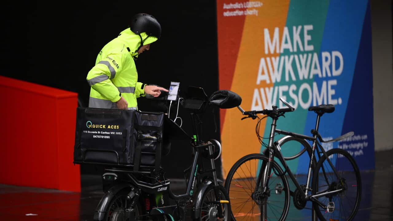 A food delivery worker in the central business district in Melbourne, Tuesday, June 3, 2025. A 3.5 per cent boost to annual pay for workers on minimum wages has been delivered by the Fair Work Commission, to help redress falling living standards.