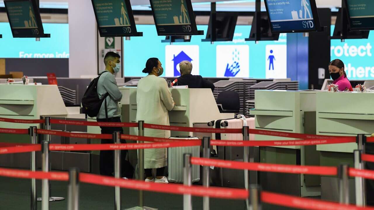 Passengers check in at Sydney airport (Getty Images).