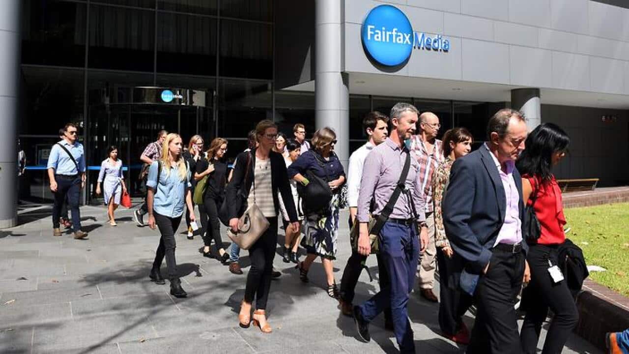 Editorial staff are seen walking out of Fairfax Media headquarters in Sydney, Thursday, March 17, 2016. (AAP)
