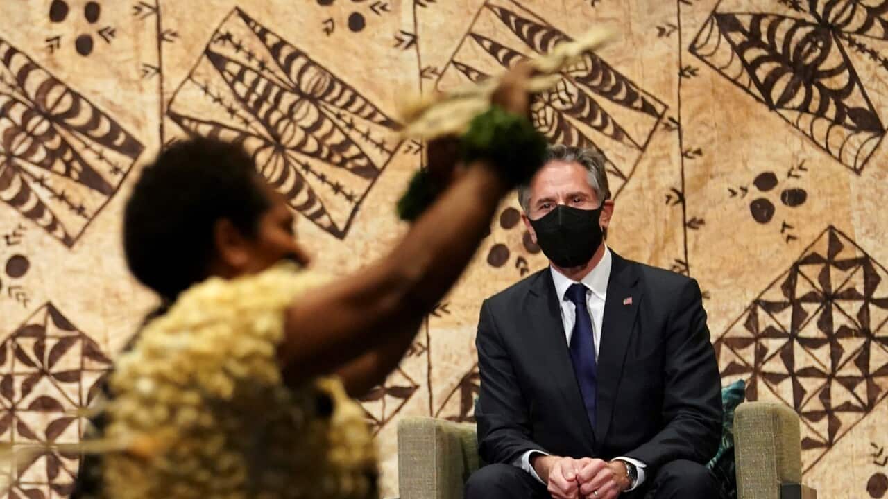 U.S. Secretary of State Antony Blinken watches a cultural farewell ceremony in Nadi, Fiji, Saturday, Feb. 12, 2022. (Kevin Lamarque/Pool Photo via AP)