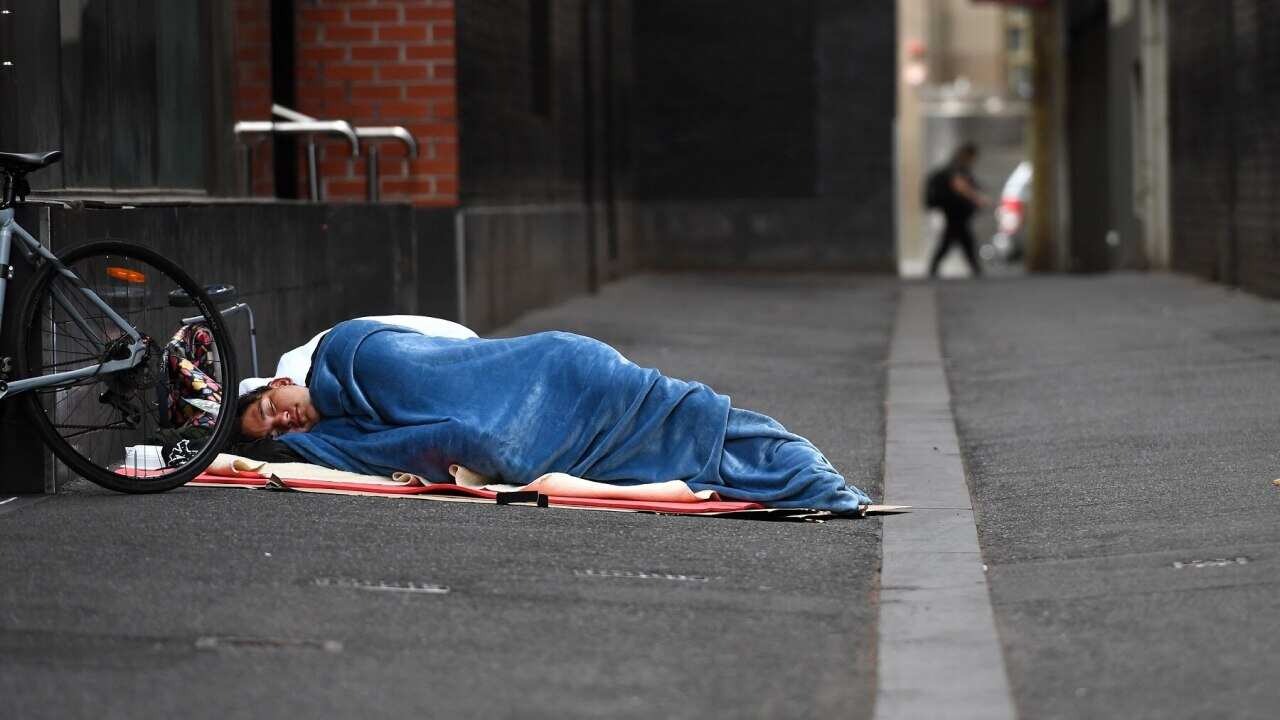 A homeless man sleeps in a laneway in Melbourne in March 2020
