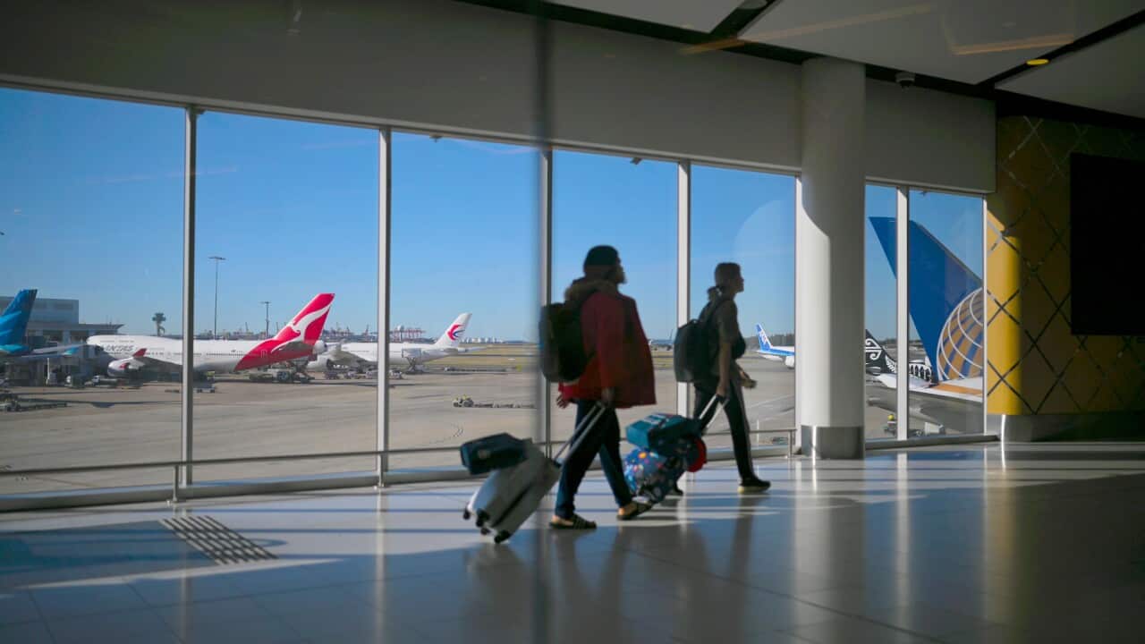 Passengers walk to their flights at Sydney International Airport