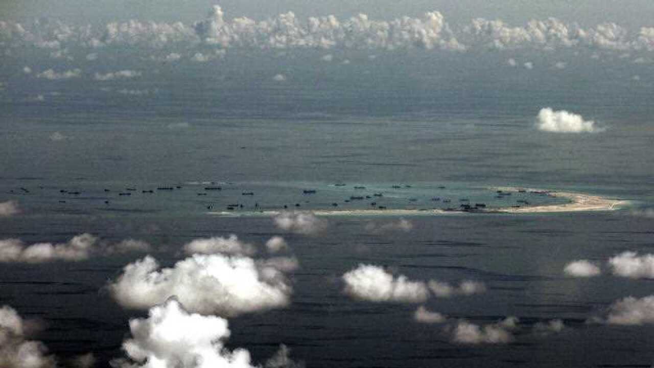 A military plane shows China's alleged on-going reclamation of Mischief Reef in the Spratly Islands in the South China Sea