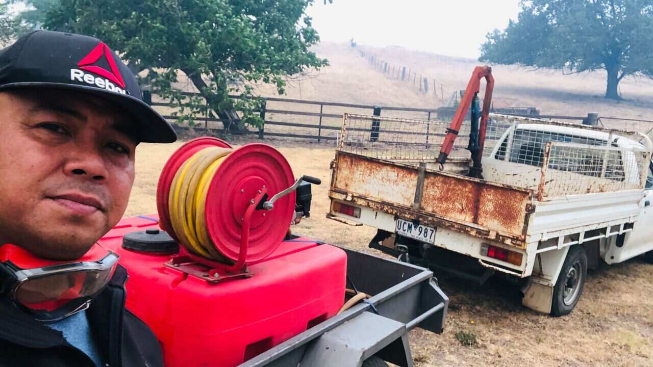 Sherwin Malenab and the vehicle used in putting out the fires thqat closed in on Corryong Health