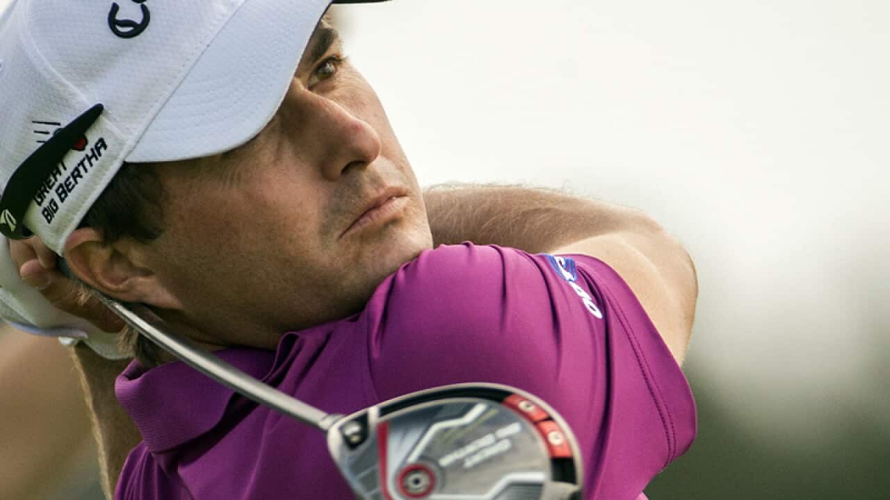 Kevin Kisner hits off the 13th tee