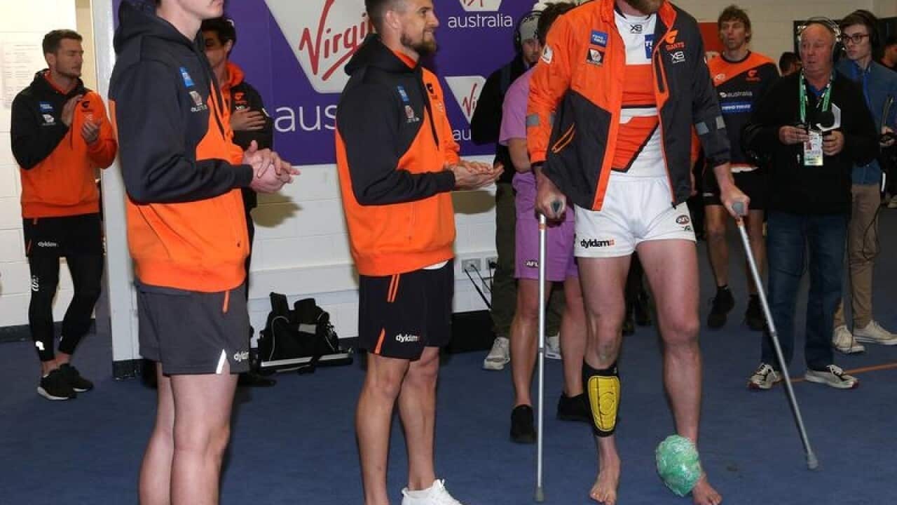 Sam Taylor, Brett Deledio and Dawson Simpson of the Giants injured.