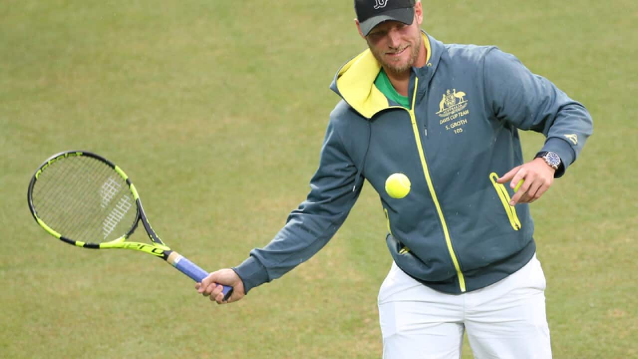 Australia's Sam Groth hits a ball into the crowd