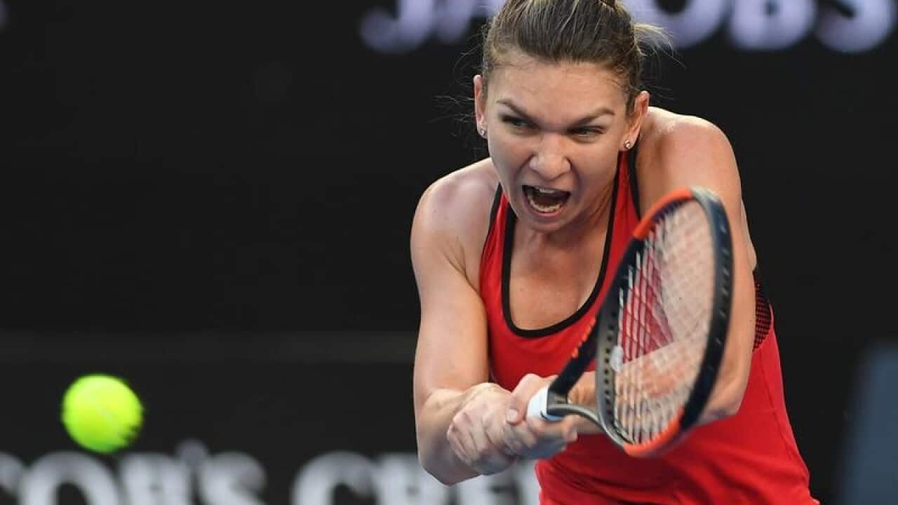 Simona Halep of Romania in action against Eugenie Bouchard.