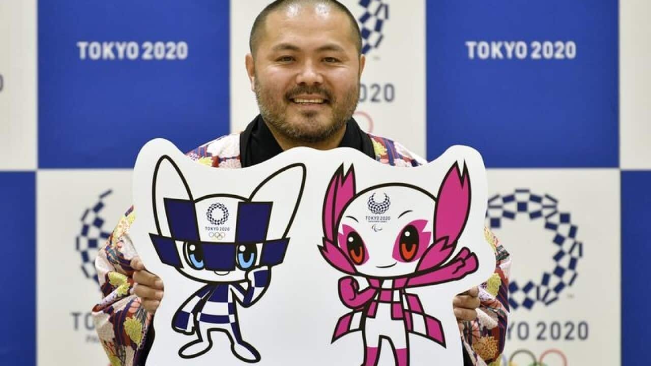 Ryo Taniguchi, poses with his Toyko 2020 Olympic mascot designs.