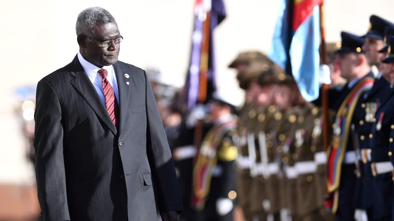 Prime Minister of the Solomon Islands Manasseh Damukana Sogavare inspects the guard of honour during a ceremonial welcome at Parliament House in Canberra, Monday, August 14, 2017. (AAP Image/Lukas Coch) NO ARCHIVING