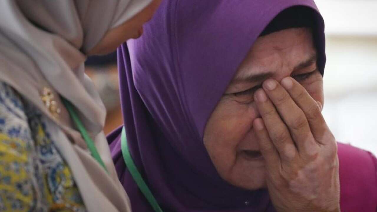 Mother of MH370 passenger cries after briefing