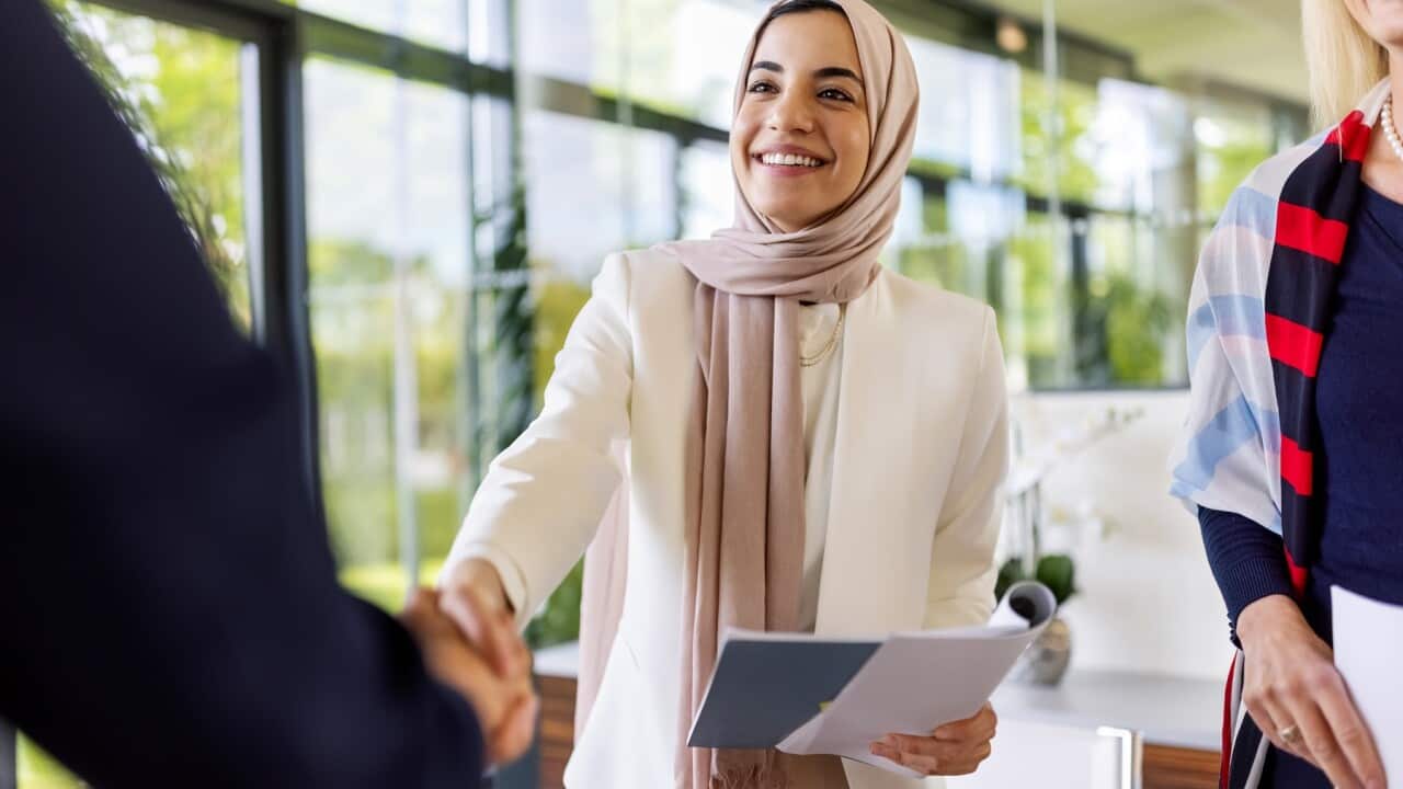 Muslim businesswomen sealing a deal with a handshake