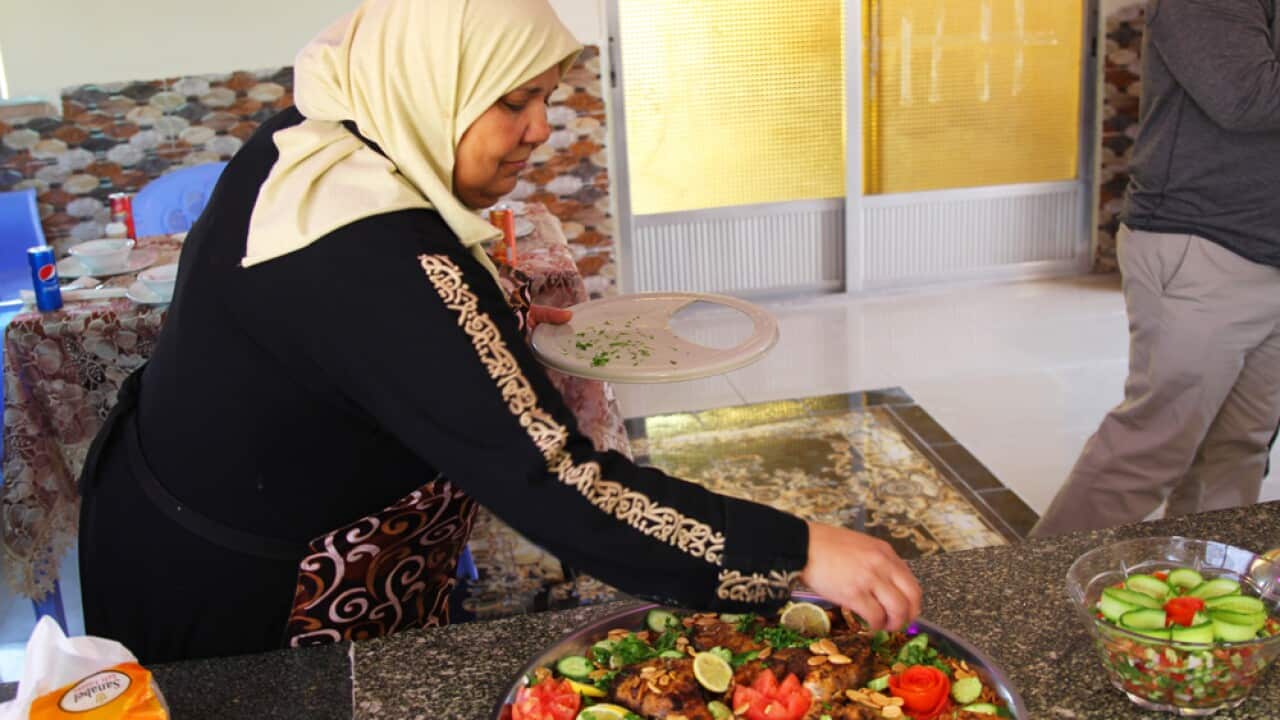 Cook Afaf Shaldan garnishing fish sayadieh.