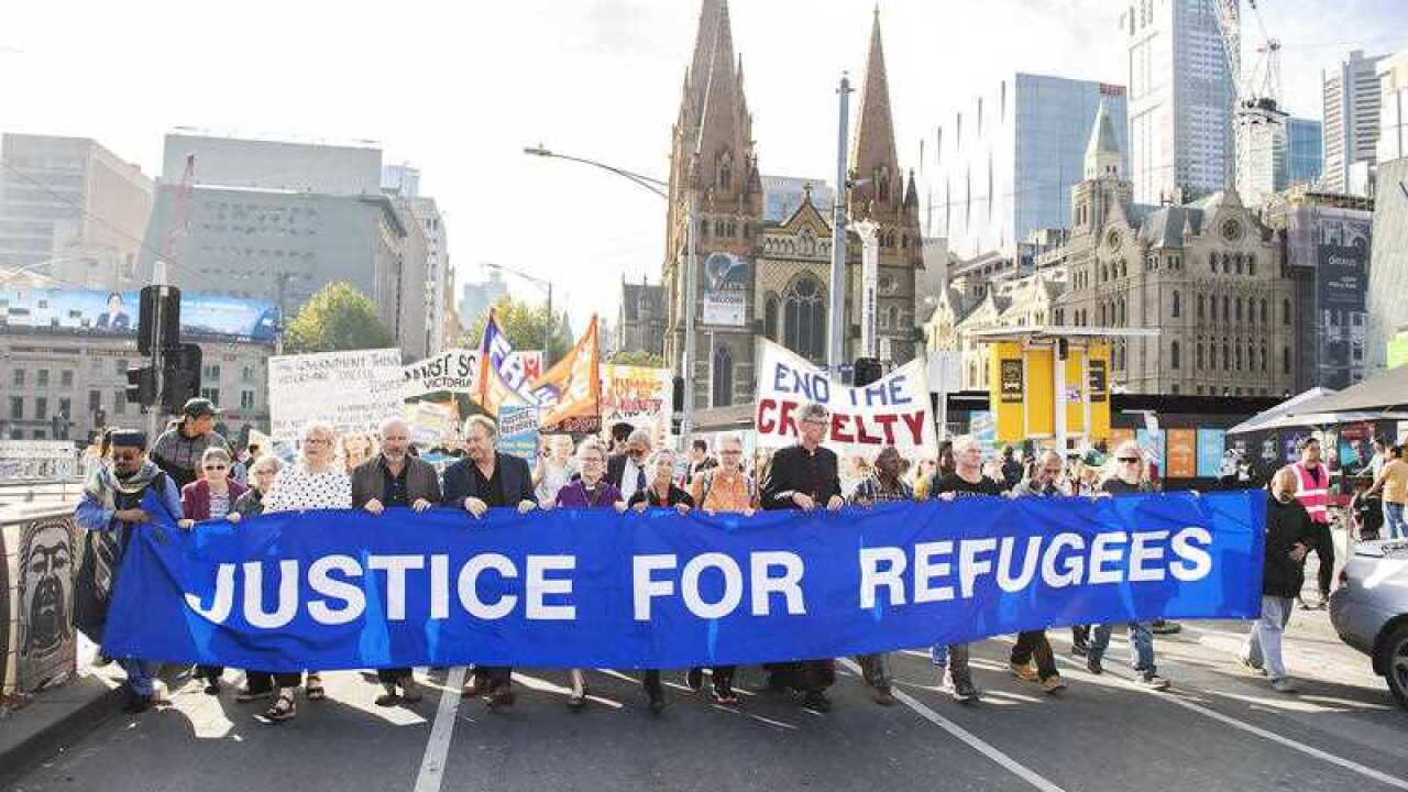 Refugee advocates at a Palm Sunday Rally outside the State Library in Melbourne