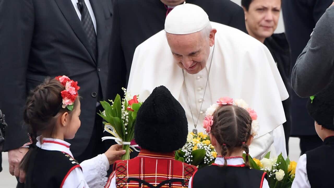 Pope Francis is welcomed by children wearing traditional costumes upon his arrival at Sofia airport, Bulgaria.