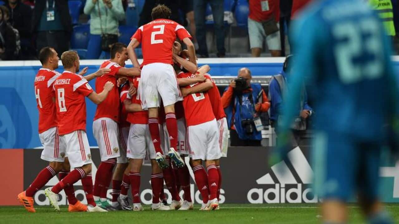 Russia's players celebrate after Egypt's defender Ahmed Fathi own goal during the Russia 2018 World Cup Group.