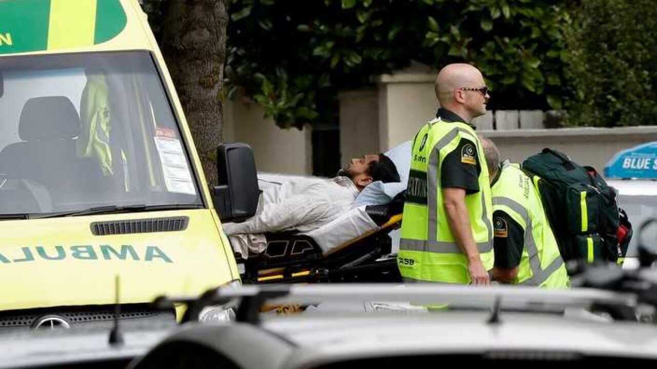 Ambulance staff take a man from outside a mosque in central Christchurch, New Zealand, Friday, March 15, 2019. A witness says many people have been killed in a mass shooting at a mosque in the New Zealand city of Christchurch.