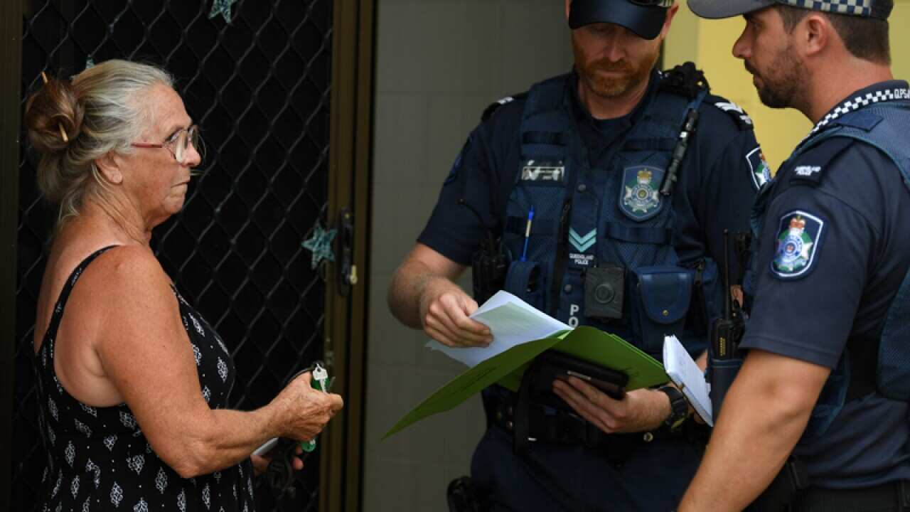 Resident advising police officers that she will not evacuate her house