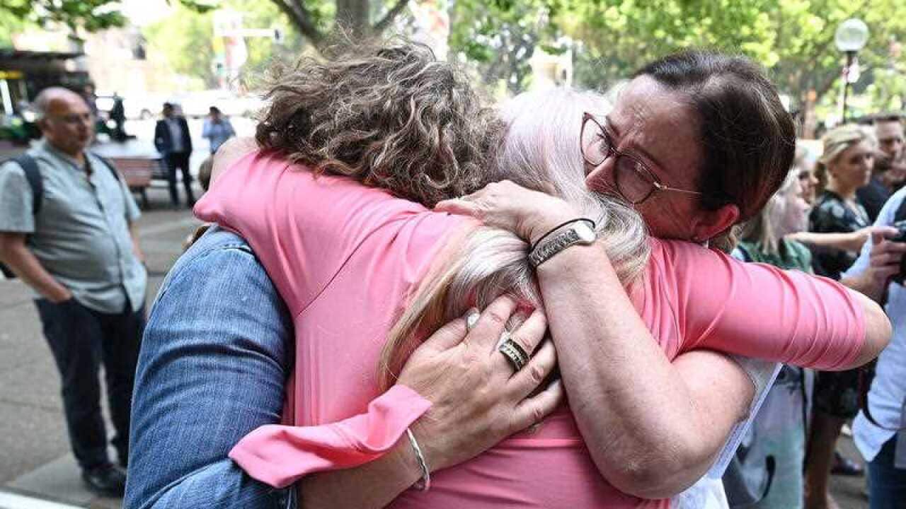 Victims embrace outside the Federal Court in Sydney when the vaginal mesh class action judgement was handed down in November