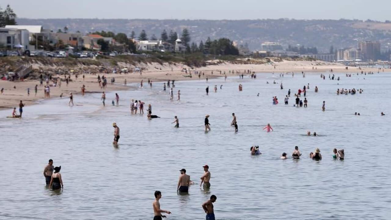 Beachgoers at Henley Beach in Adelaide.