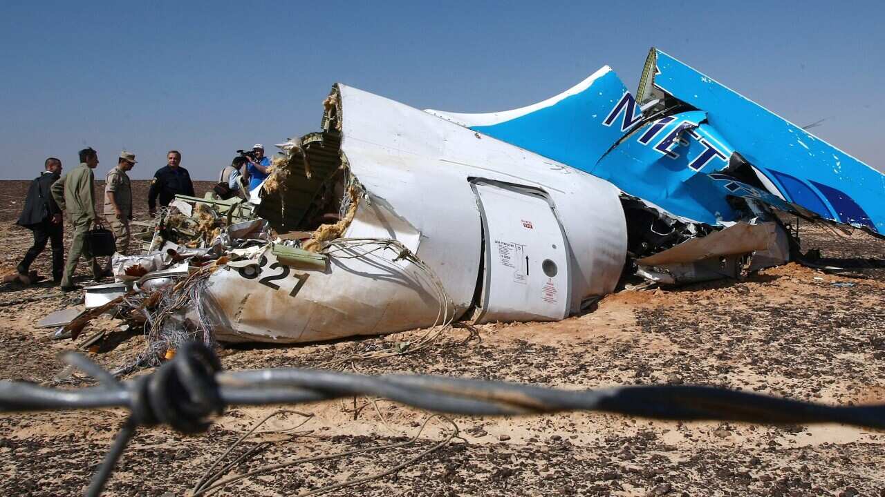 Russian Emergency Situations Minister Vladimir Puchkov and unidentified officials near a piece of wreckage of Russian MetroJet Airbus A321 at the site of the crash in Sinai, Egypt, 01 November 2015.