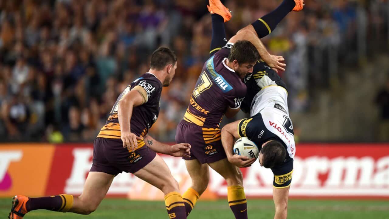 Kane Linnett (right) of the Cowboys is tackled by Ben Hunt.