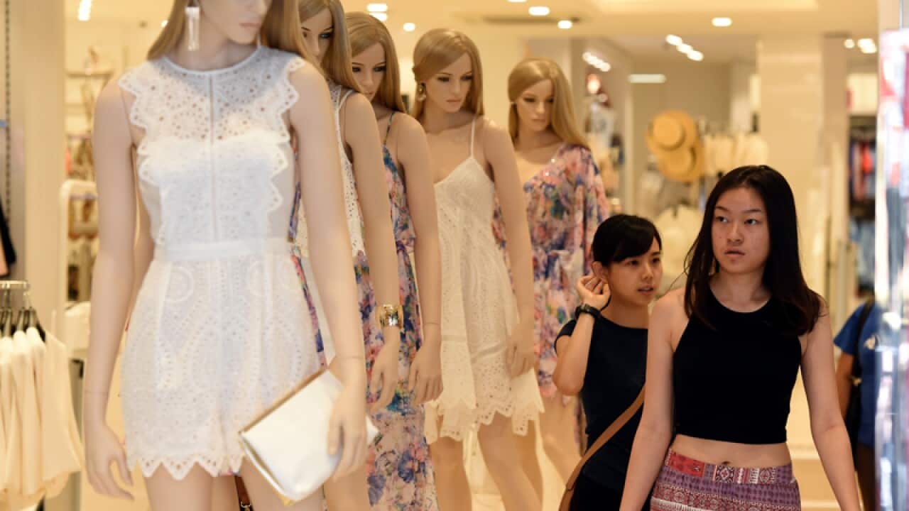 Shoppers inspect merchandise