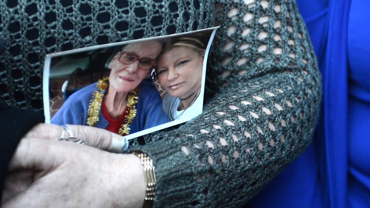 Donna Austin holds a picture of herself and her mother Alma Smith who died in the Quakers Hill Nursing home fire as she leaves the Supreme Court after Roger Dean was sentenced to life for the murder of 11 nursing home residents