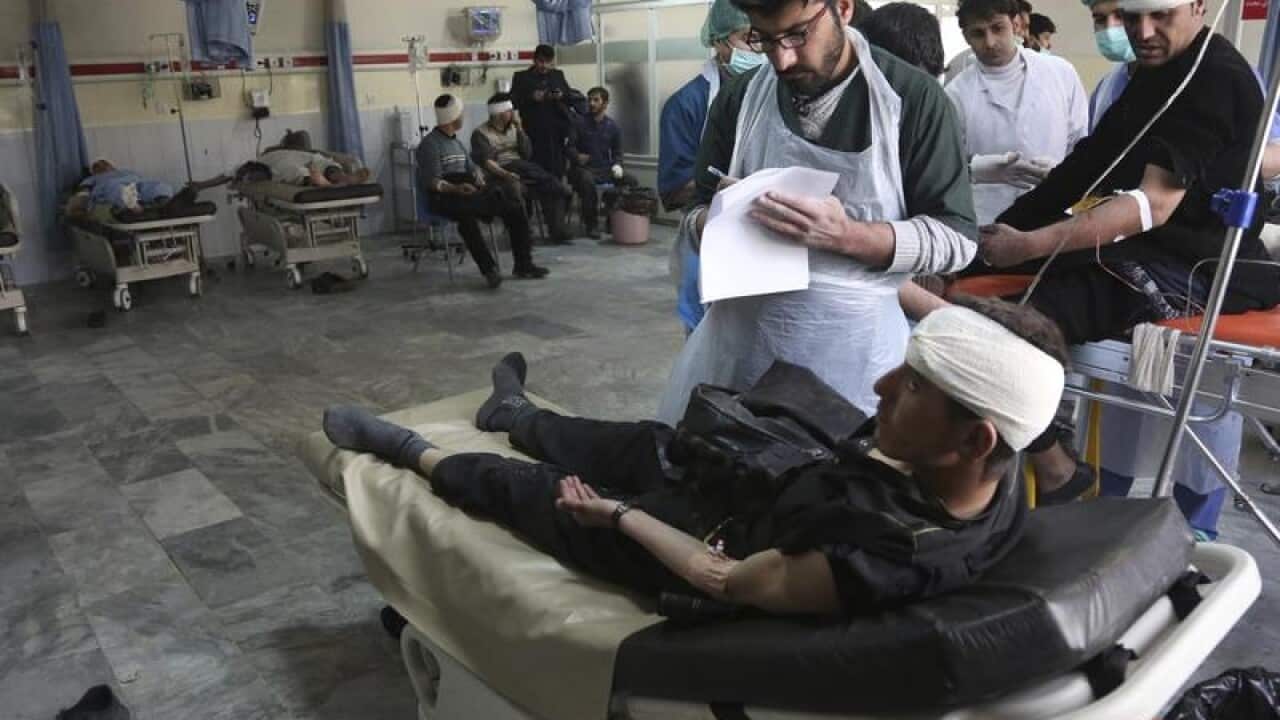 Wounded men are treated in a Kabul hospital after a suicide bombing