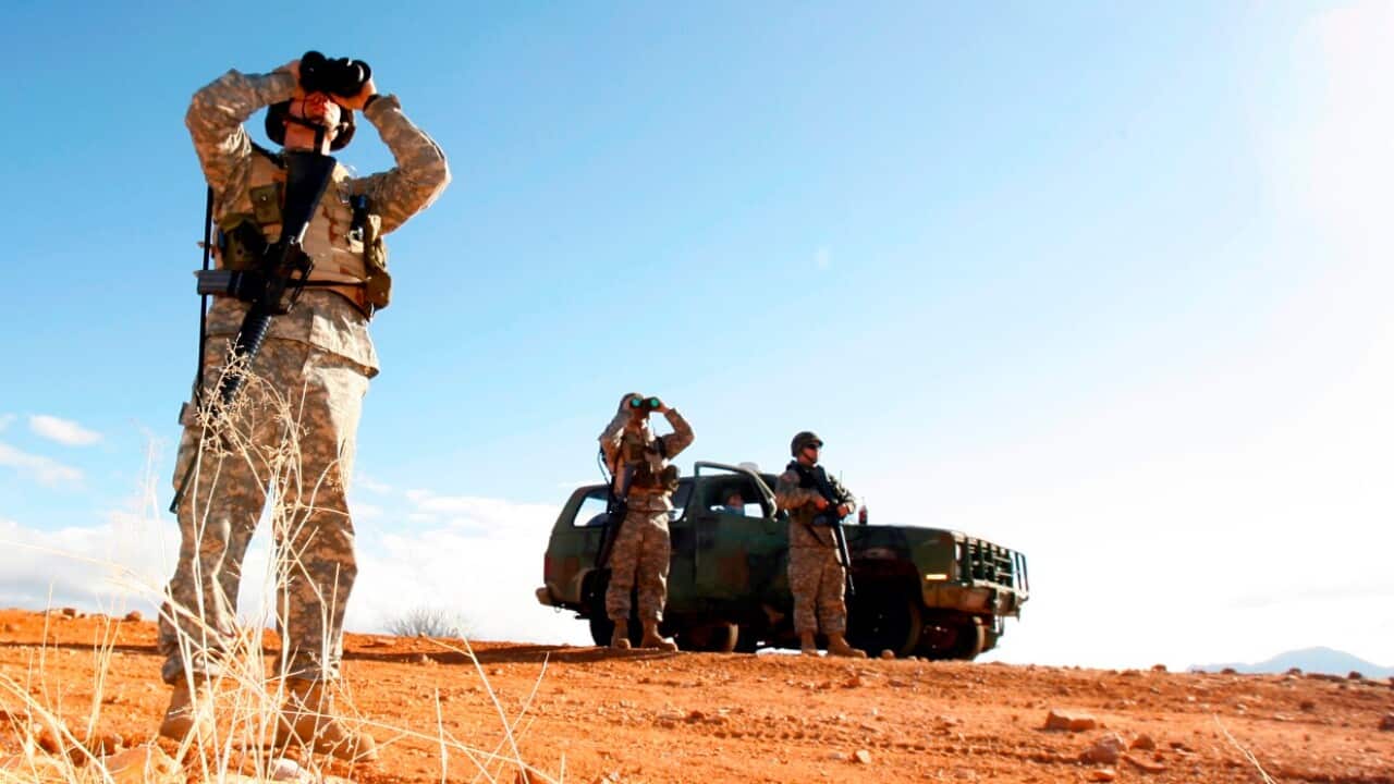 In this Friday, Jan. 19, 2007 file photo, a National Guard unit patrols the Arizona-Mexico border in Sasabe, Ariz.