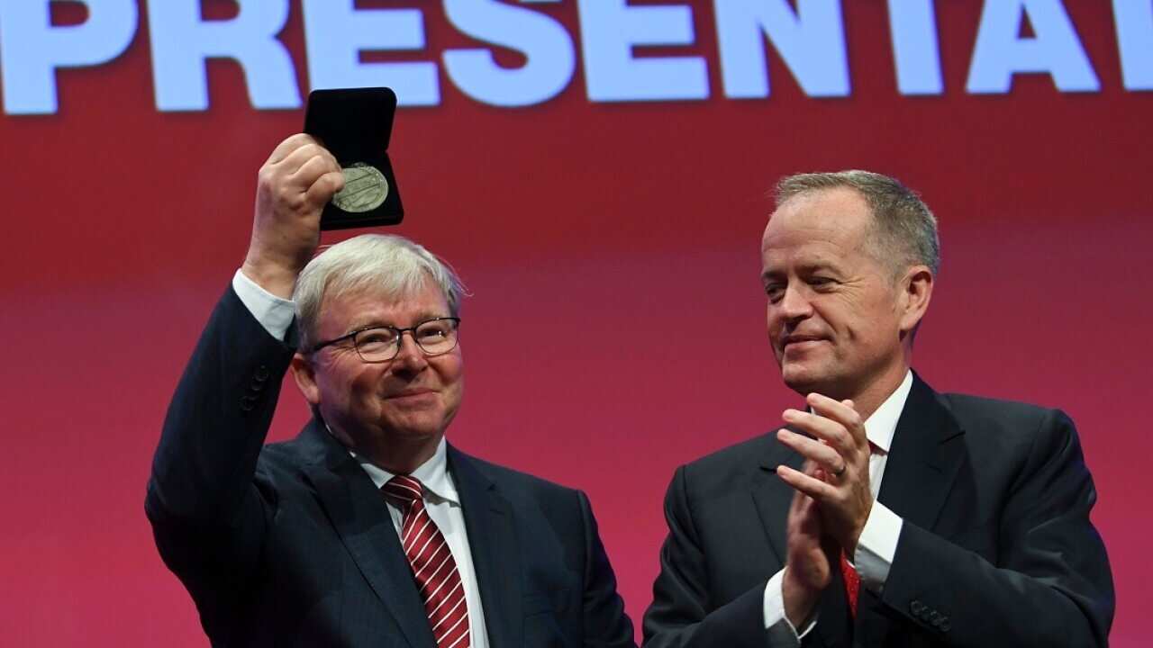 Former Prime Minister Kevin Rudd (left) is congratulated by Opposition Leader Bill Shorten.