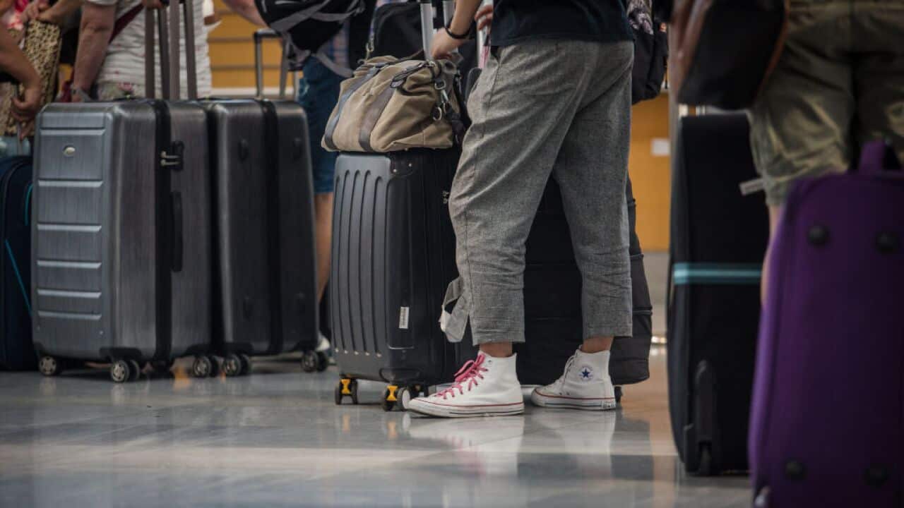 Passengers waiting to check in their luggage at the terminal of Stuttgart Airport.