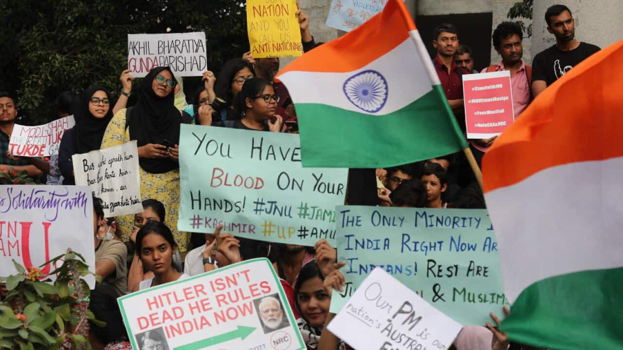 Indian students, professors and activists hold placards during a protest at the JNU campus at New Delhi
